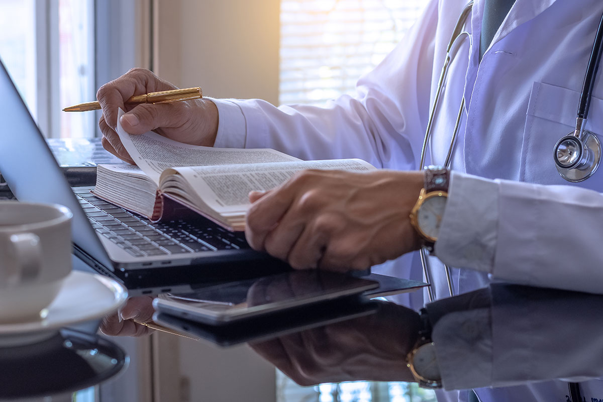 doctor studying and reading medical textbook